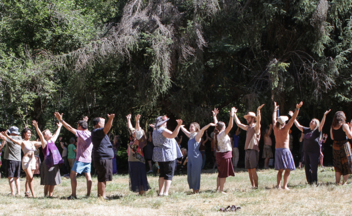 people standing in a circle greeting each other